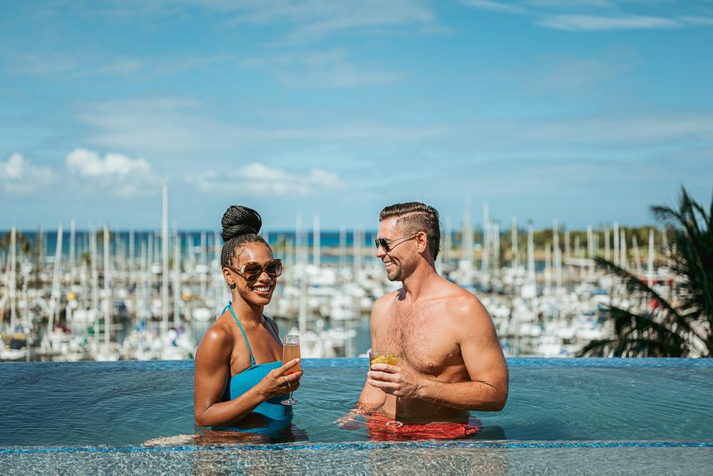 A man and woman relax in the pool at Prince Waikiki
