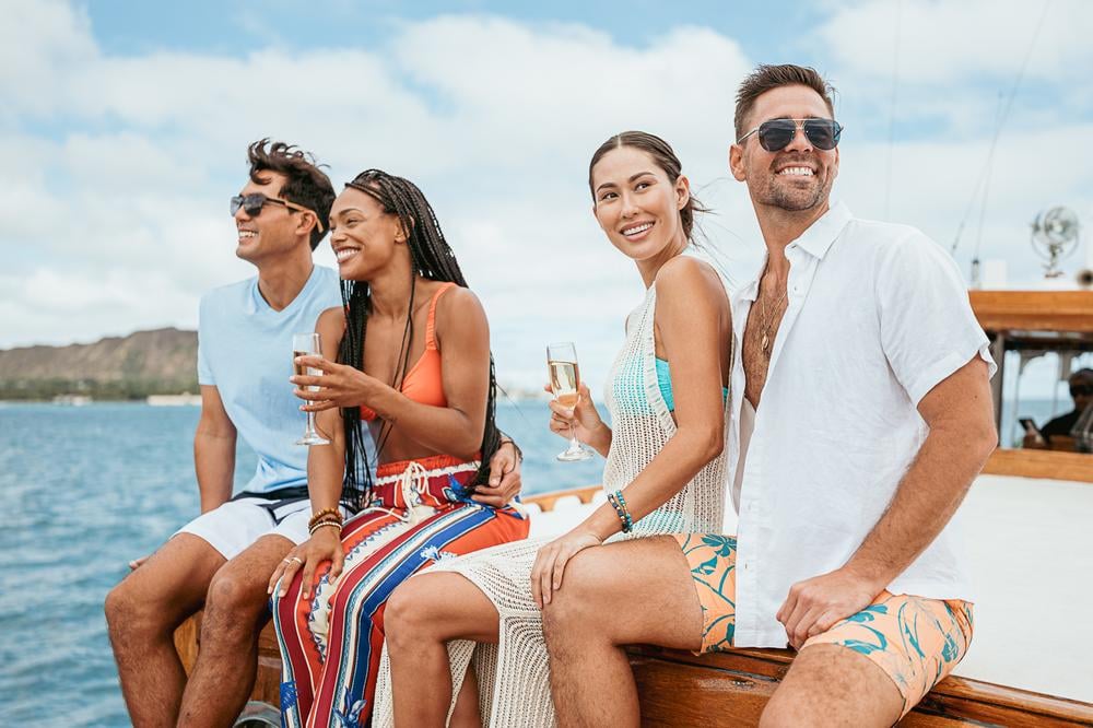 Two couples on the Vita Mia Yacht enjoying the ocean views in Honolulu, Hawaii.