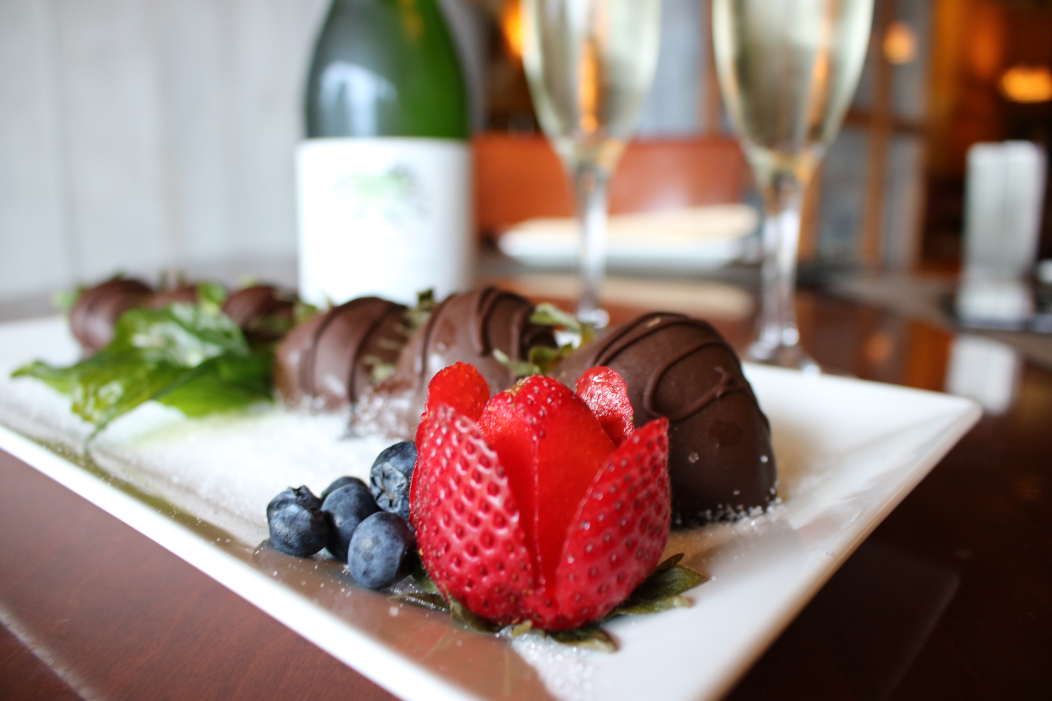 Sweet chocolate covered strawberries with sparkling wine