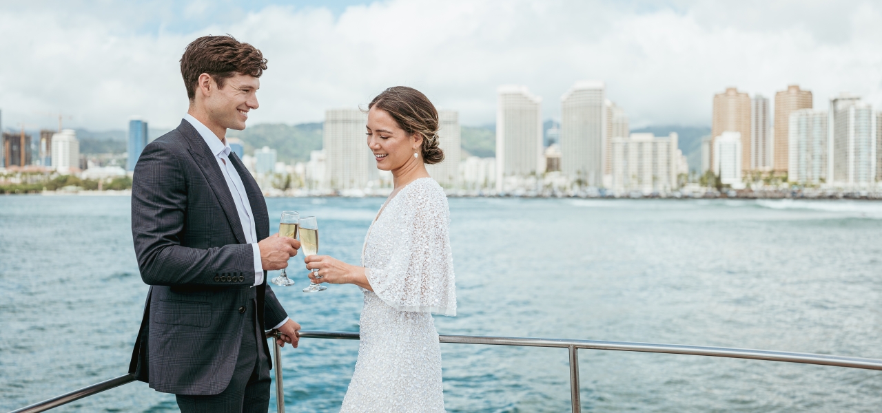 A man and a woman toast to a romantic getaway at Prince Waikiki