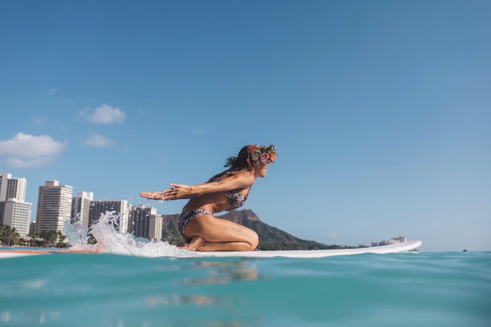 A woman surfs at Waikiki Beach
