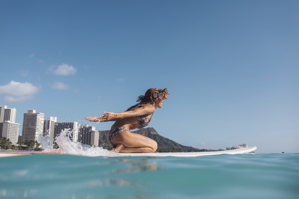 A woman surfs at Waikiki Beach