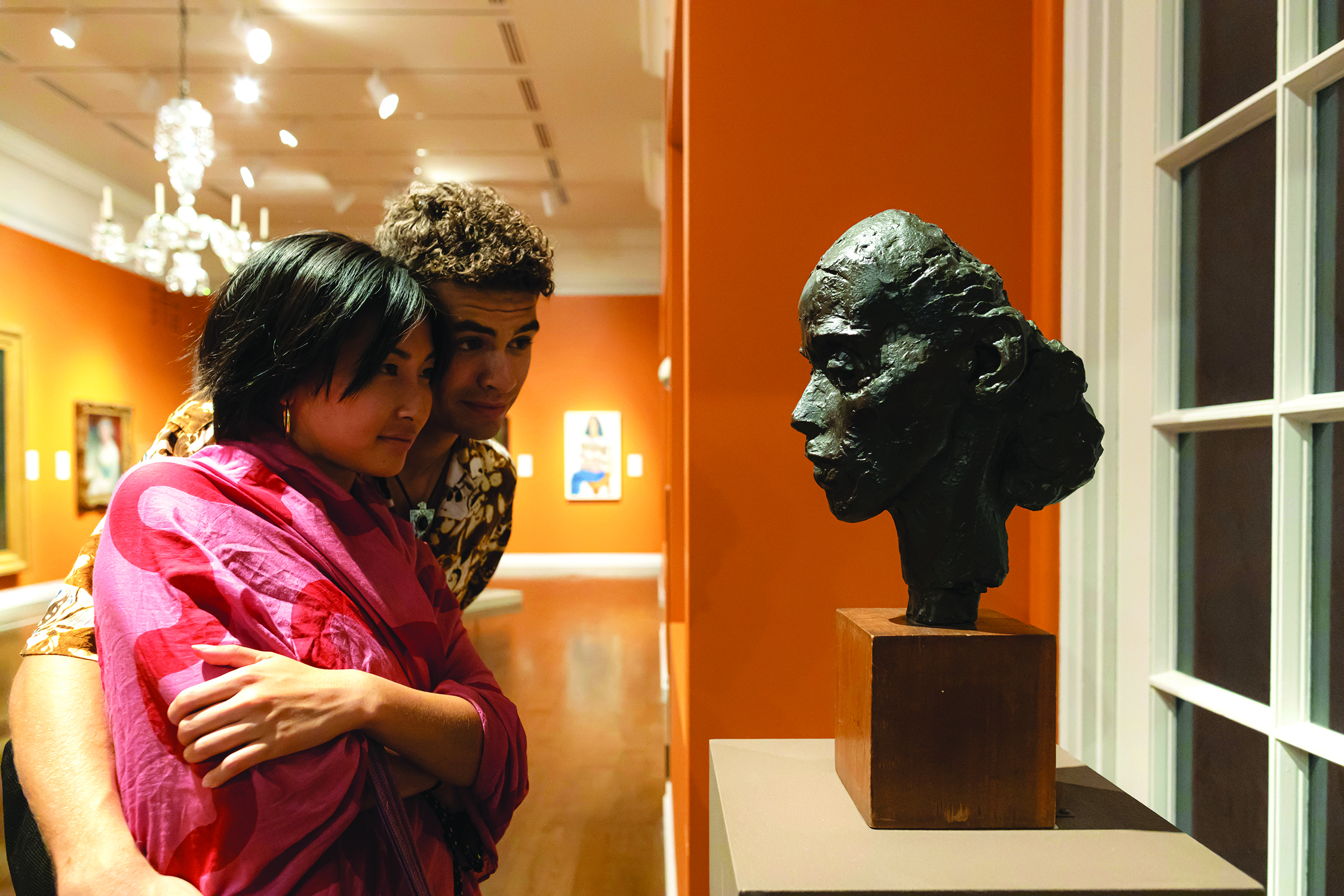 A couple looking at a face sculpture at the Honolulu Museum of Art (HoMA) in Honolulu, HI.