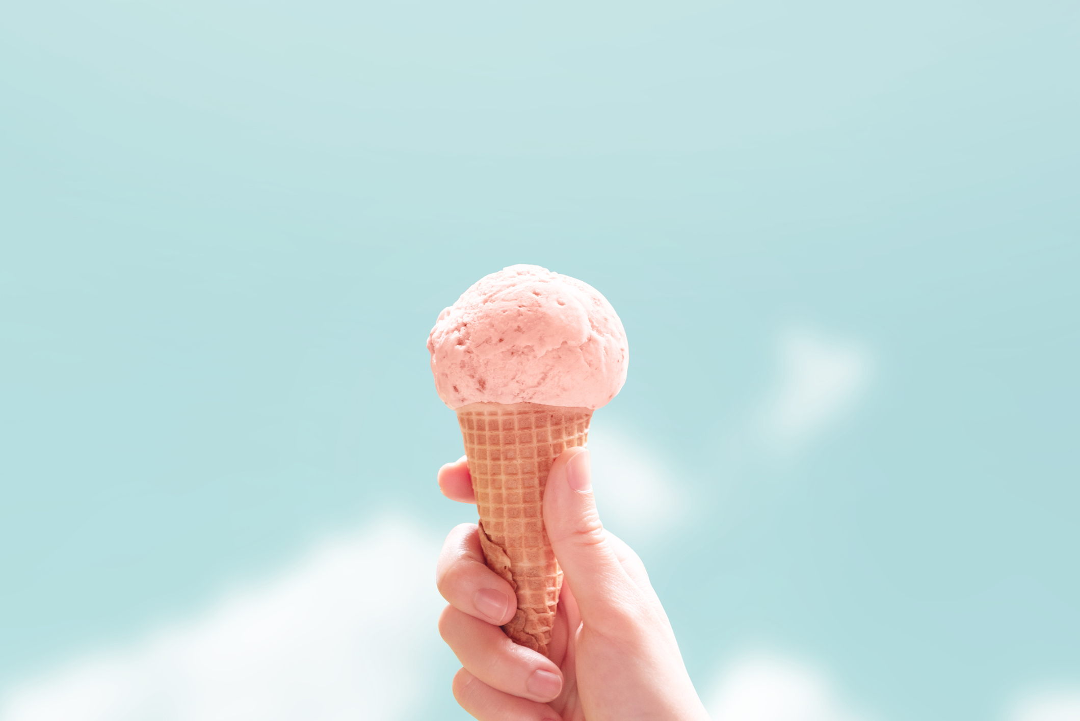 Young woman hands holding ice cream cone