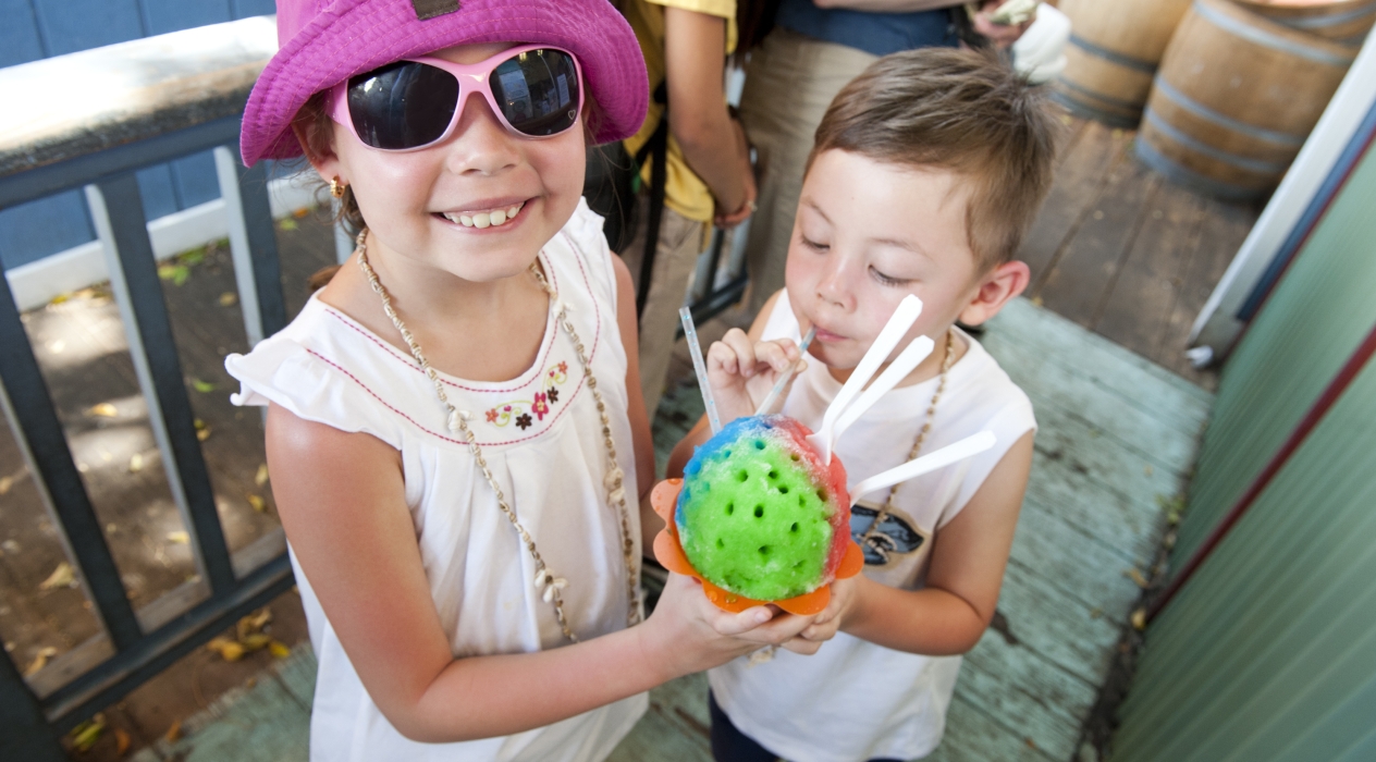Two children share an order of shave ice