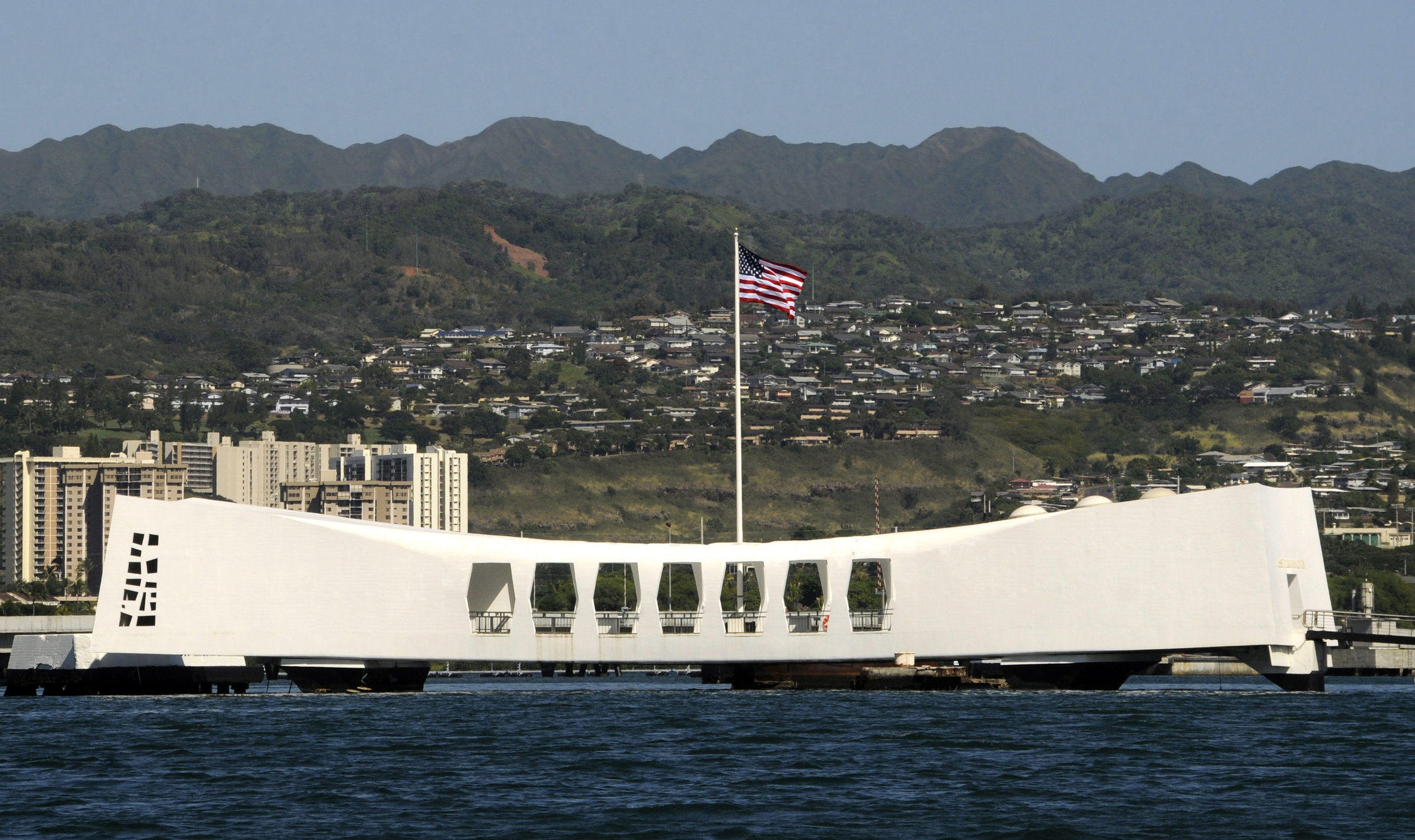 The Ensign flies over the USS Arizona Memorial in Honolulu, Hawaii