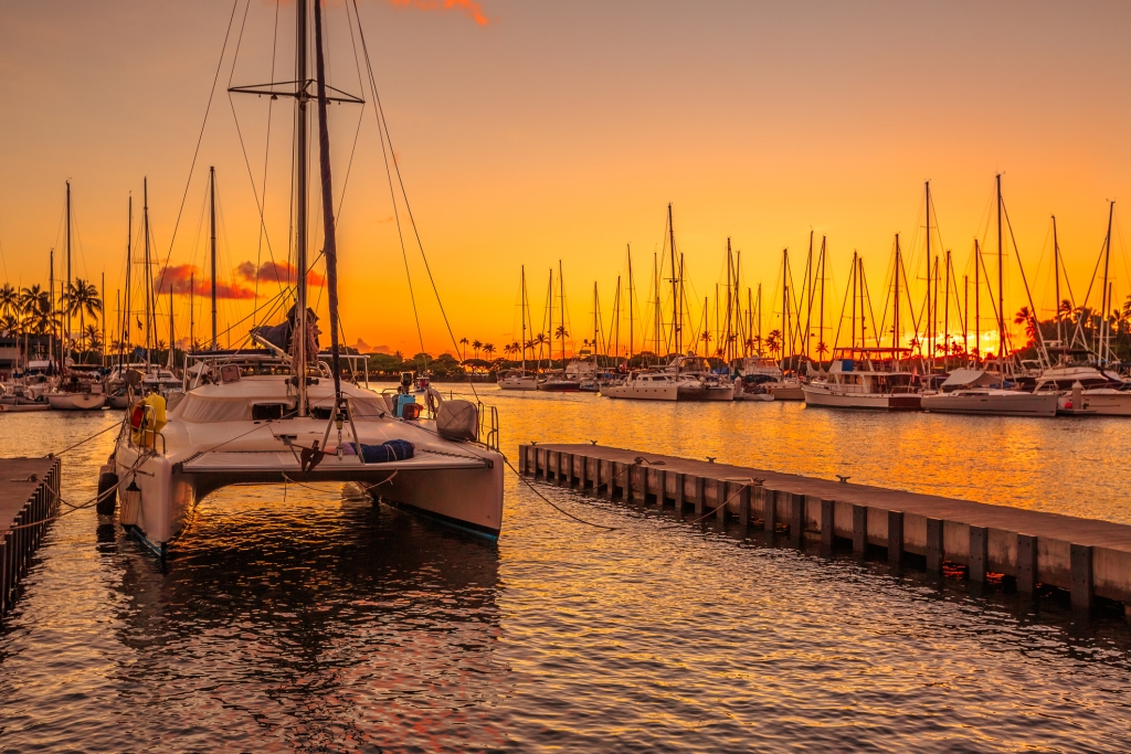 Catamaran docked at the Ala Wai Harbor at sunset.